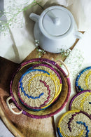 Sikki grass hand woven colourful tea coater set is kept on a table with tea pot
