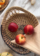 Apple decorated on sikki hand crafted tray with swirl pattern, kept on the table