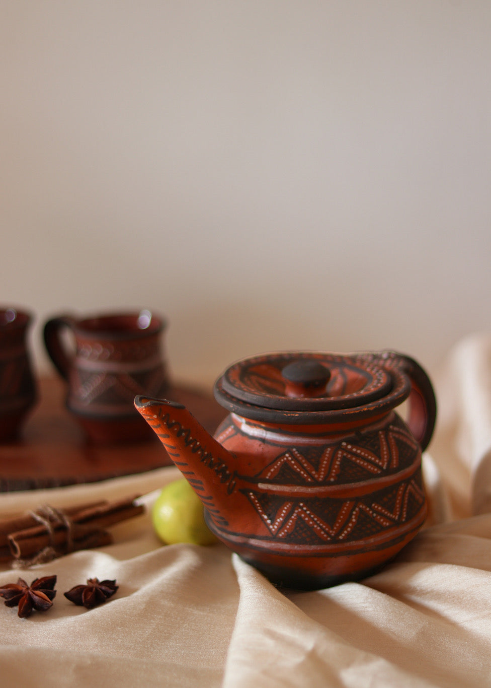 Red clay hand painted tea pot kept on the table