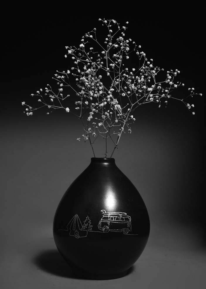 black clay vase with silver inlay motifs are kept on the table