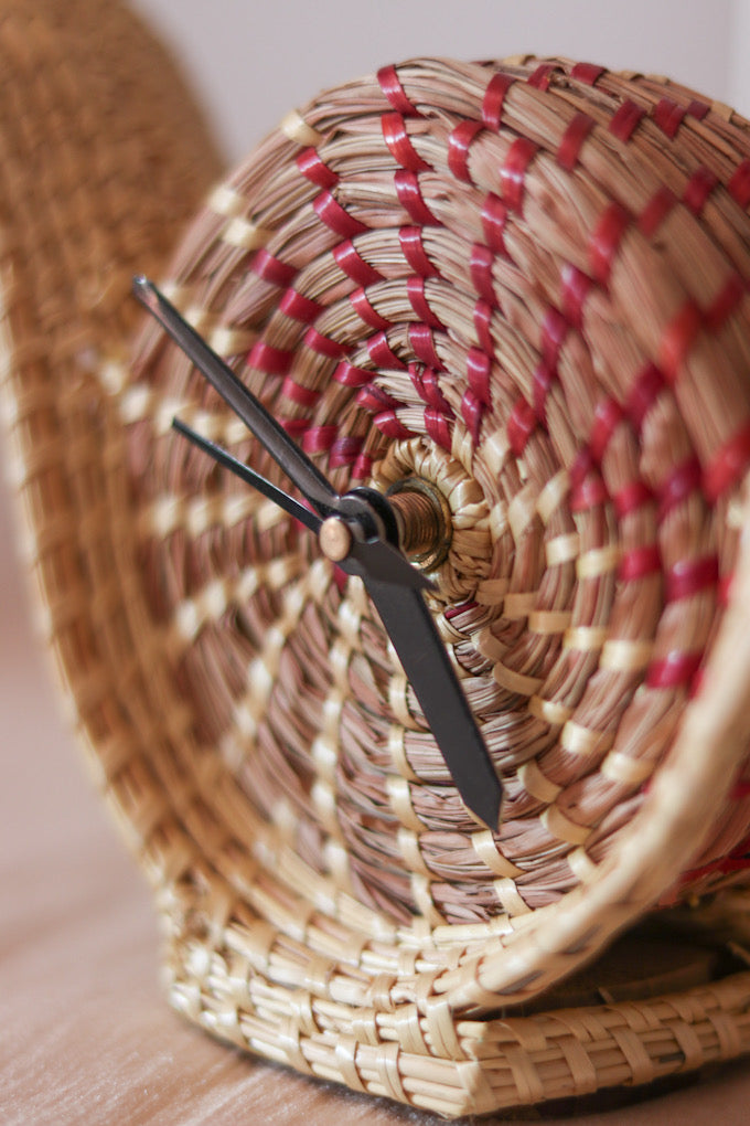 hand woven snail shaped table clock kept on table