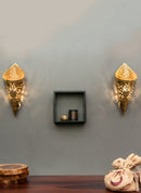Brass embossed and cut out wall lights are hung on the wall