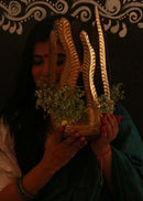 a woman is holding a Hand embossed planter brass planter 