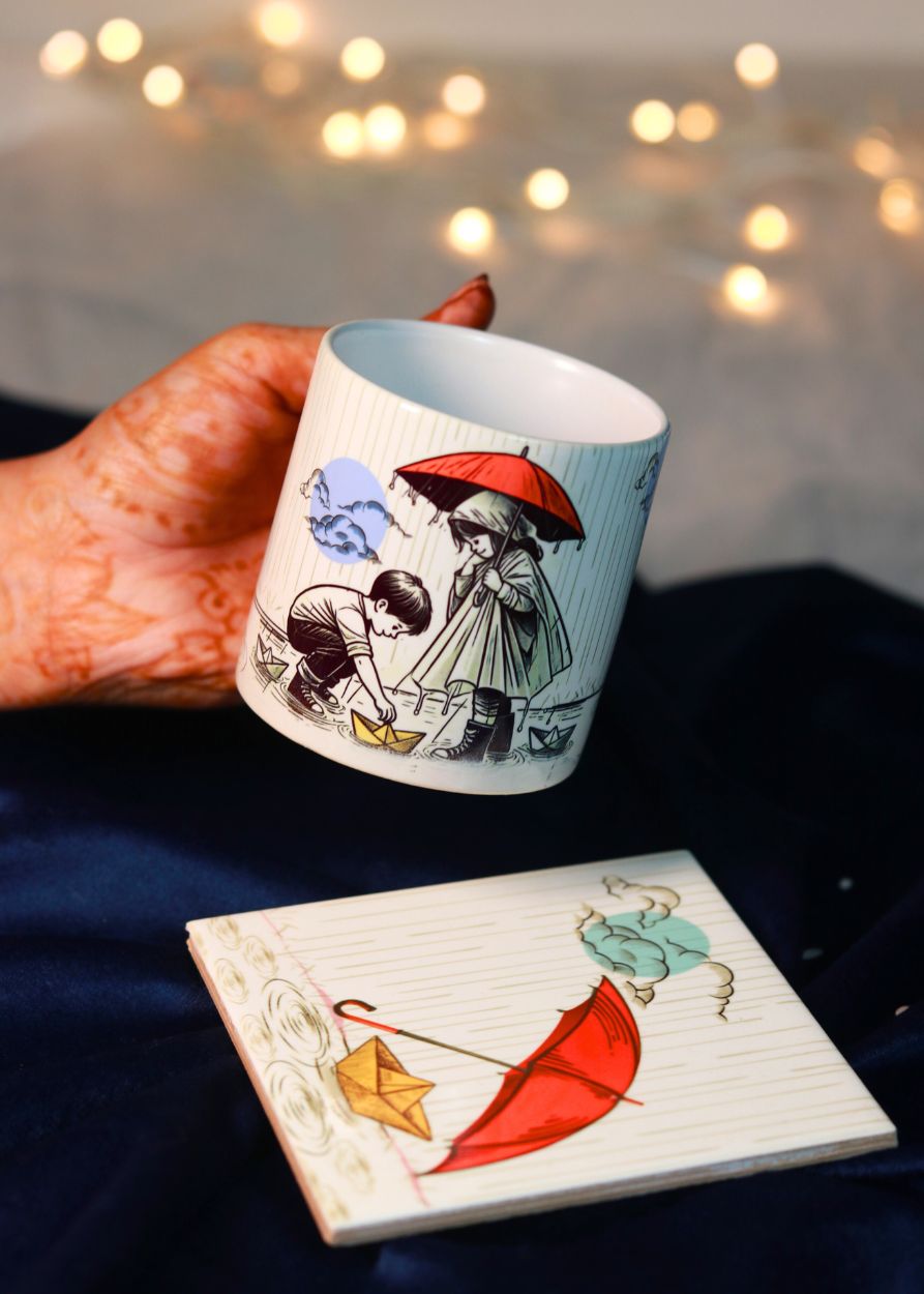 a printed ceramic coffee mug kept on printed ceramic coaster