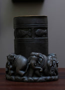 Black stone hand carved candle light in the shape of elephant is kept on a table