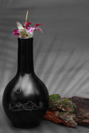 black clay vases with silver inlay motifs are kept on the table decorated with purple flower