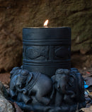 Black stone hand carved candle light in the shape of elephant is kept in a cave