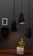 black stone sculpted pendant light is hanging above a table